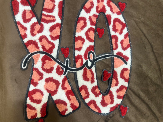 XO chenille patch on crewneck sweatshirt